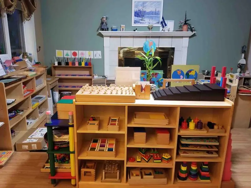 Alternate wide angle view of the main classroom, showing accessible low shelving and learning stations.