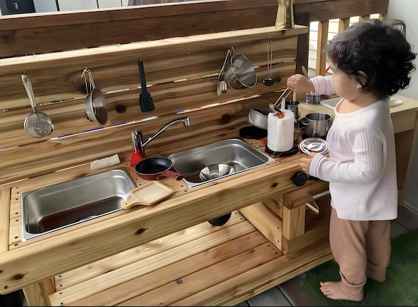 A young girl safely slicing soft fruit with a child-safe knife, learning practical life and culinary skills.